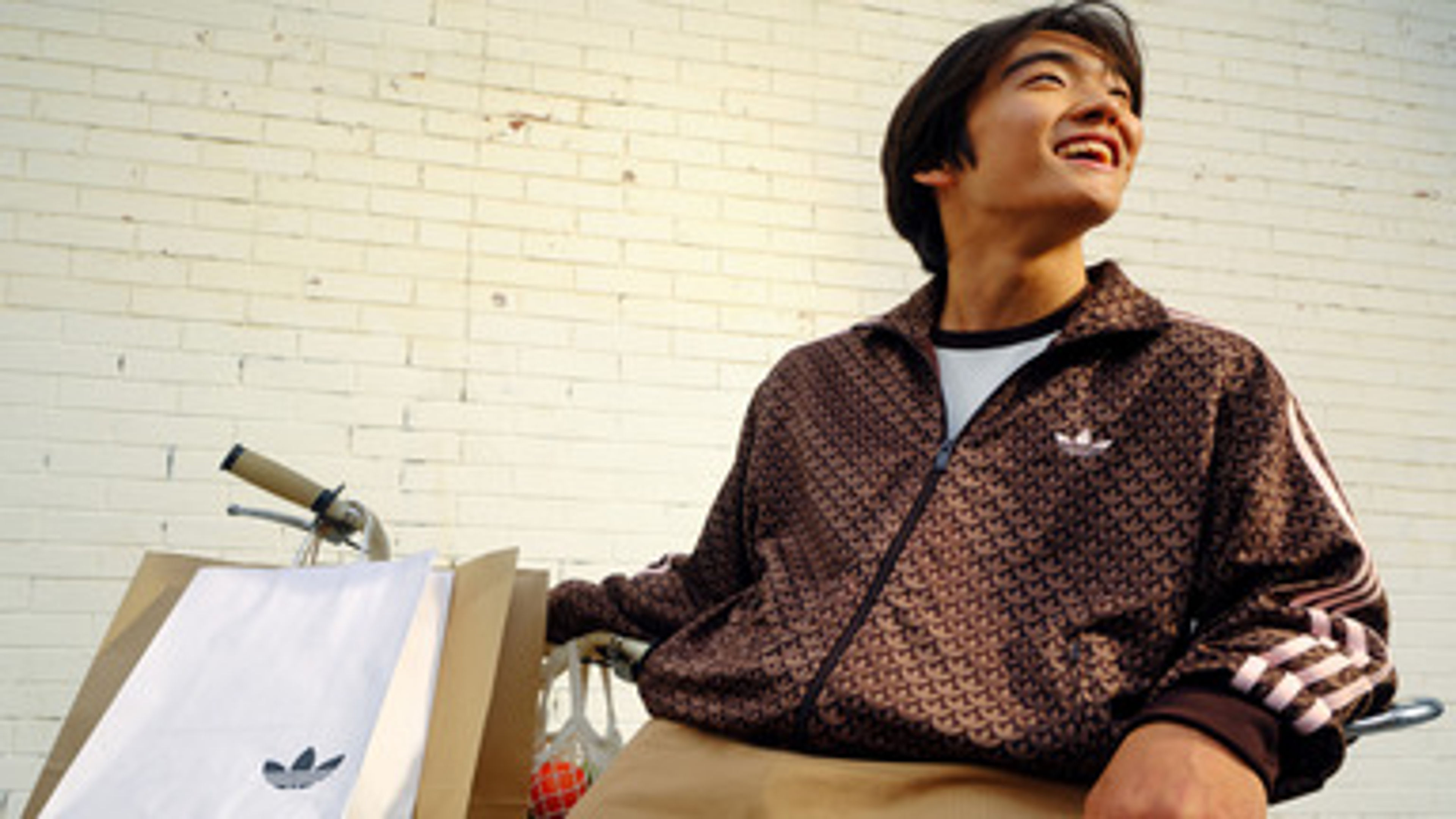 Smiling Person With Adidas Outfit And Shopping Bags