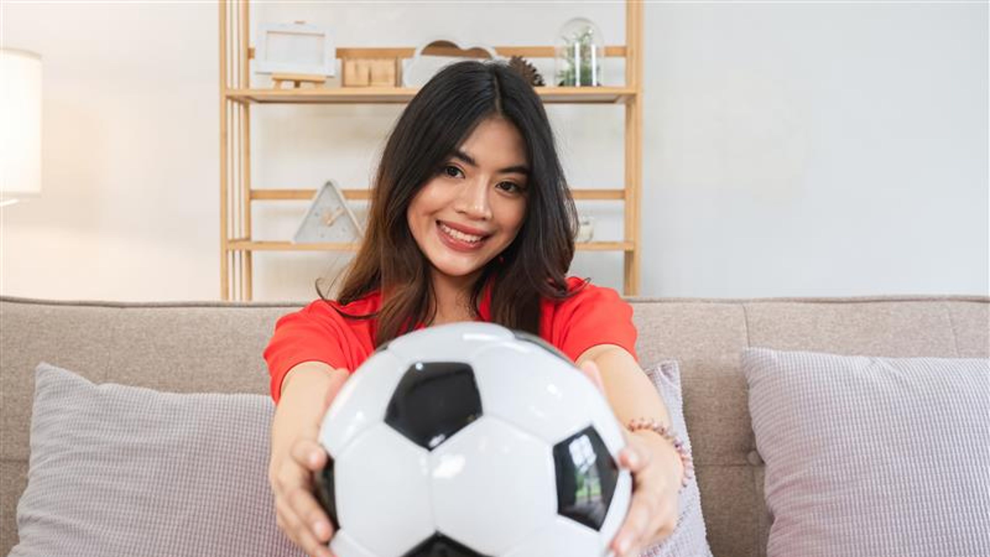 A woman holding a football