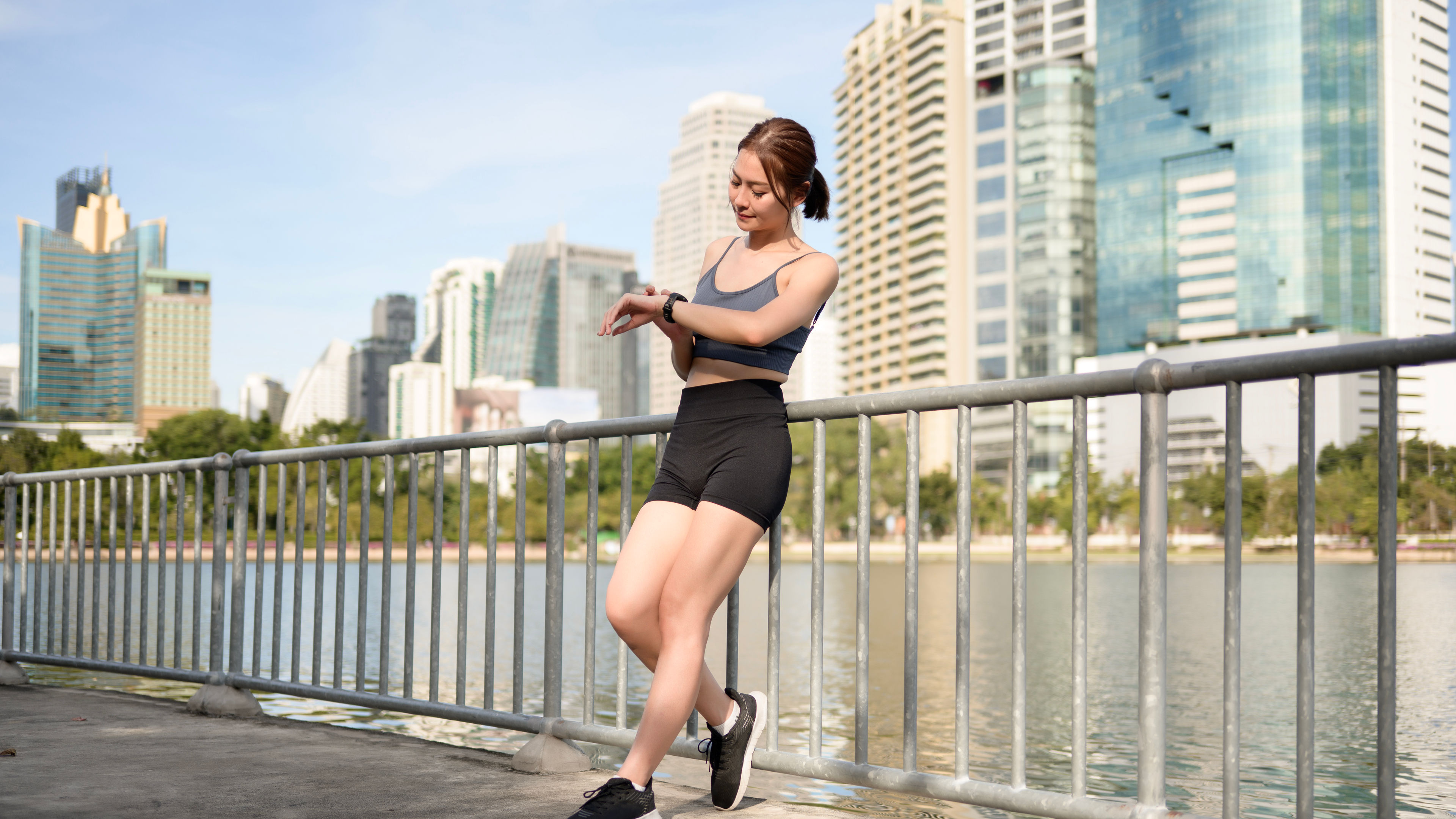 Active Woman Leaning Against Railing