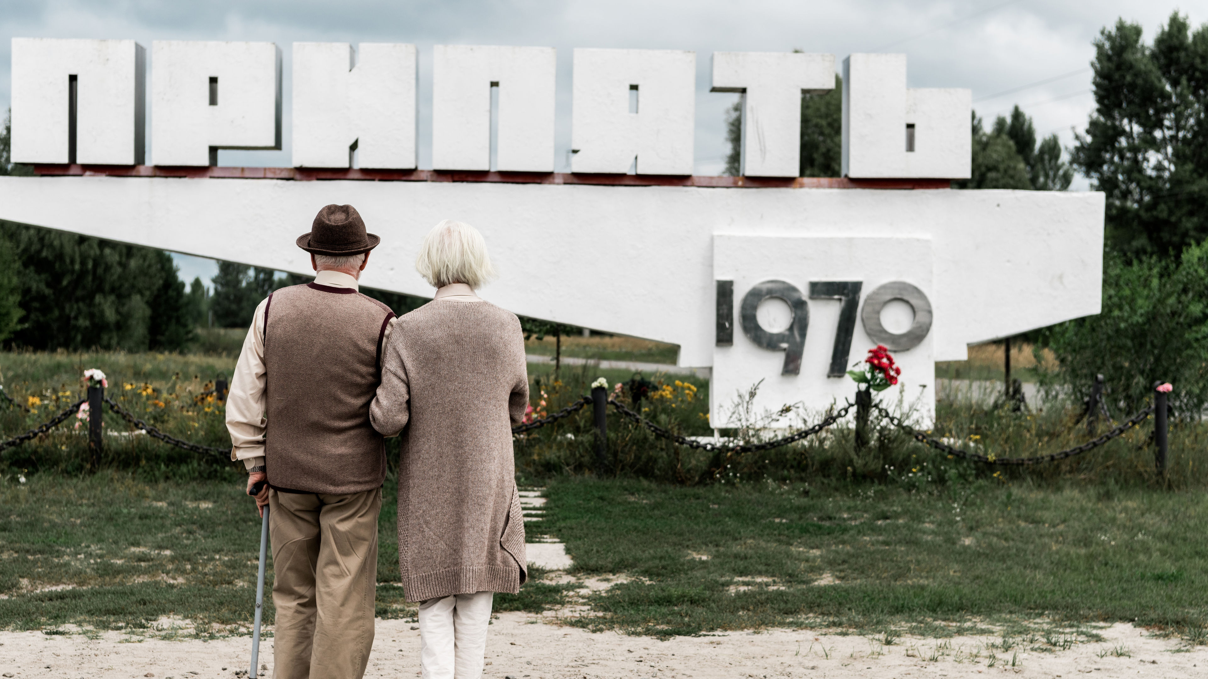 
An elderly couple facing a large monument