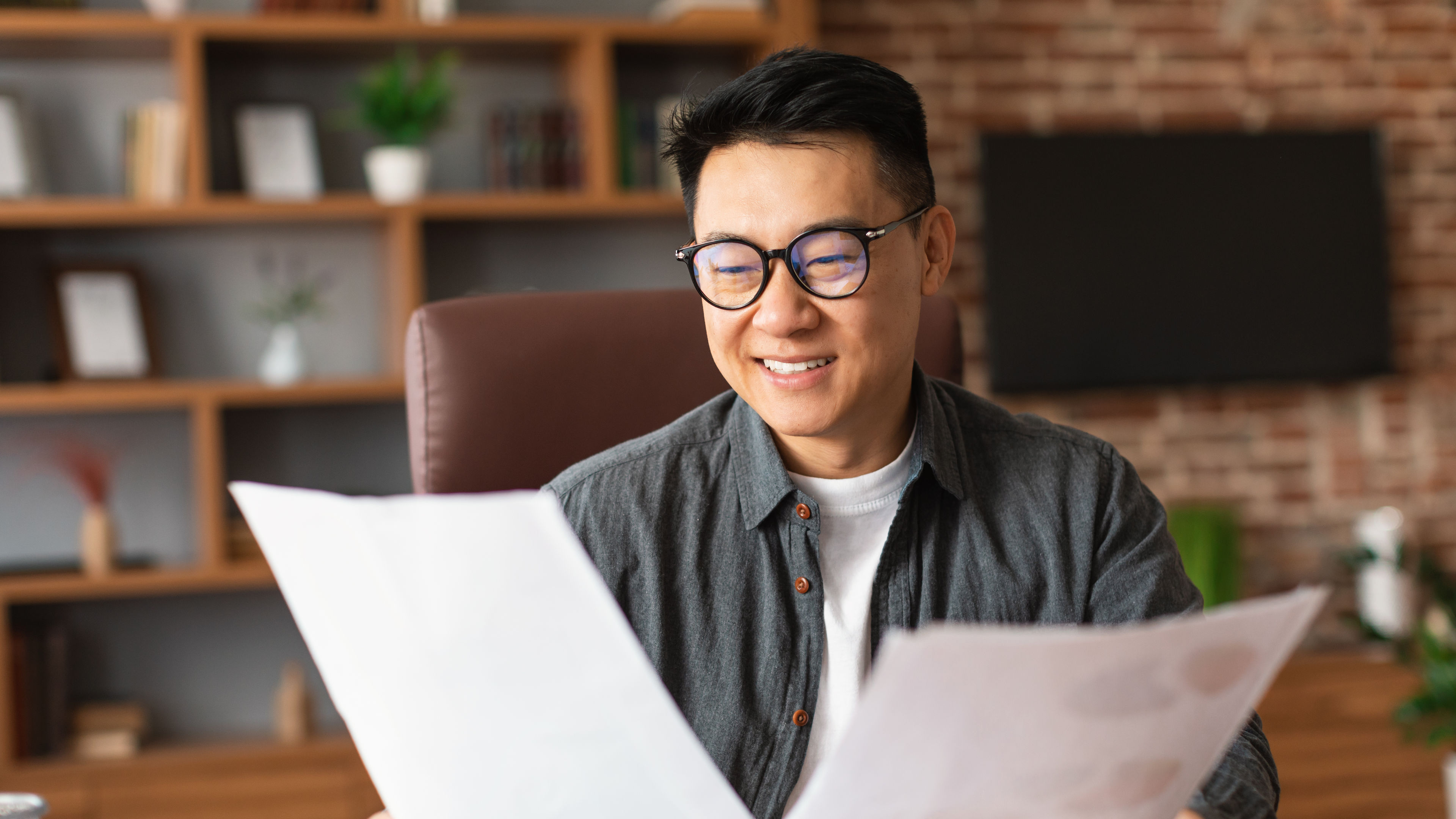 businessman in glasses works with documents for insurance 