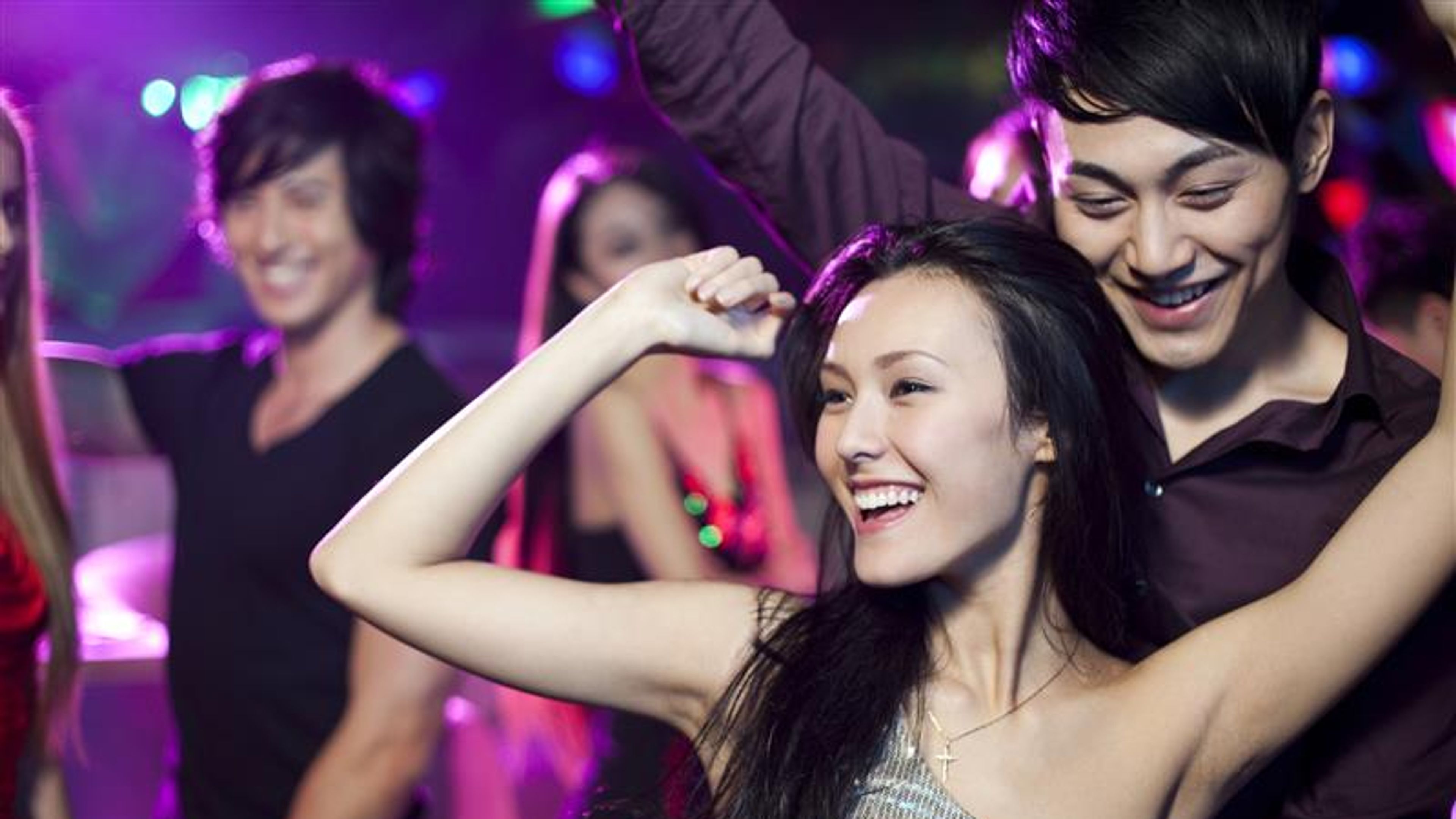 Friends dancing at night.