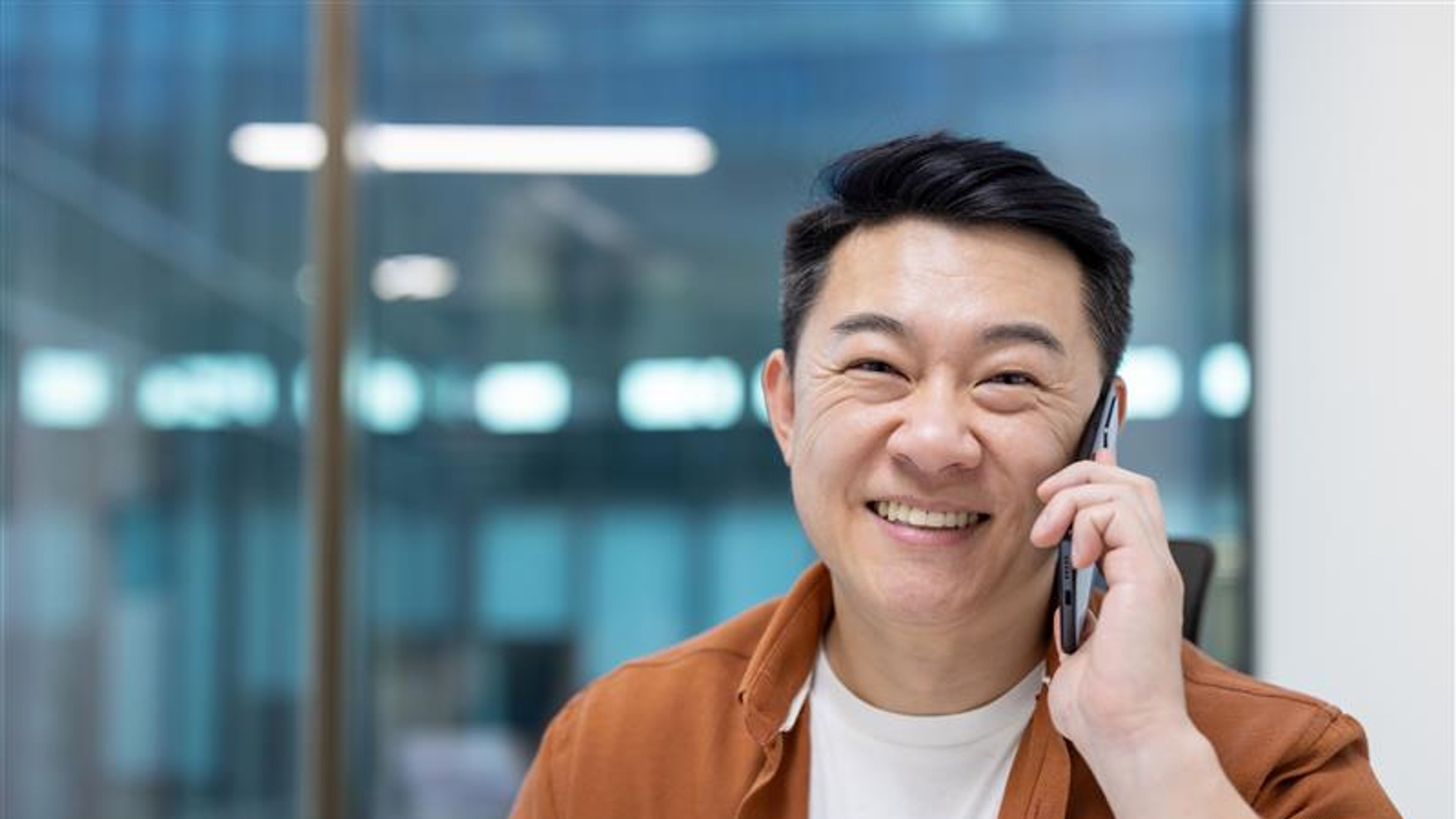 Man talking on the phone with a smile