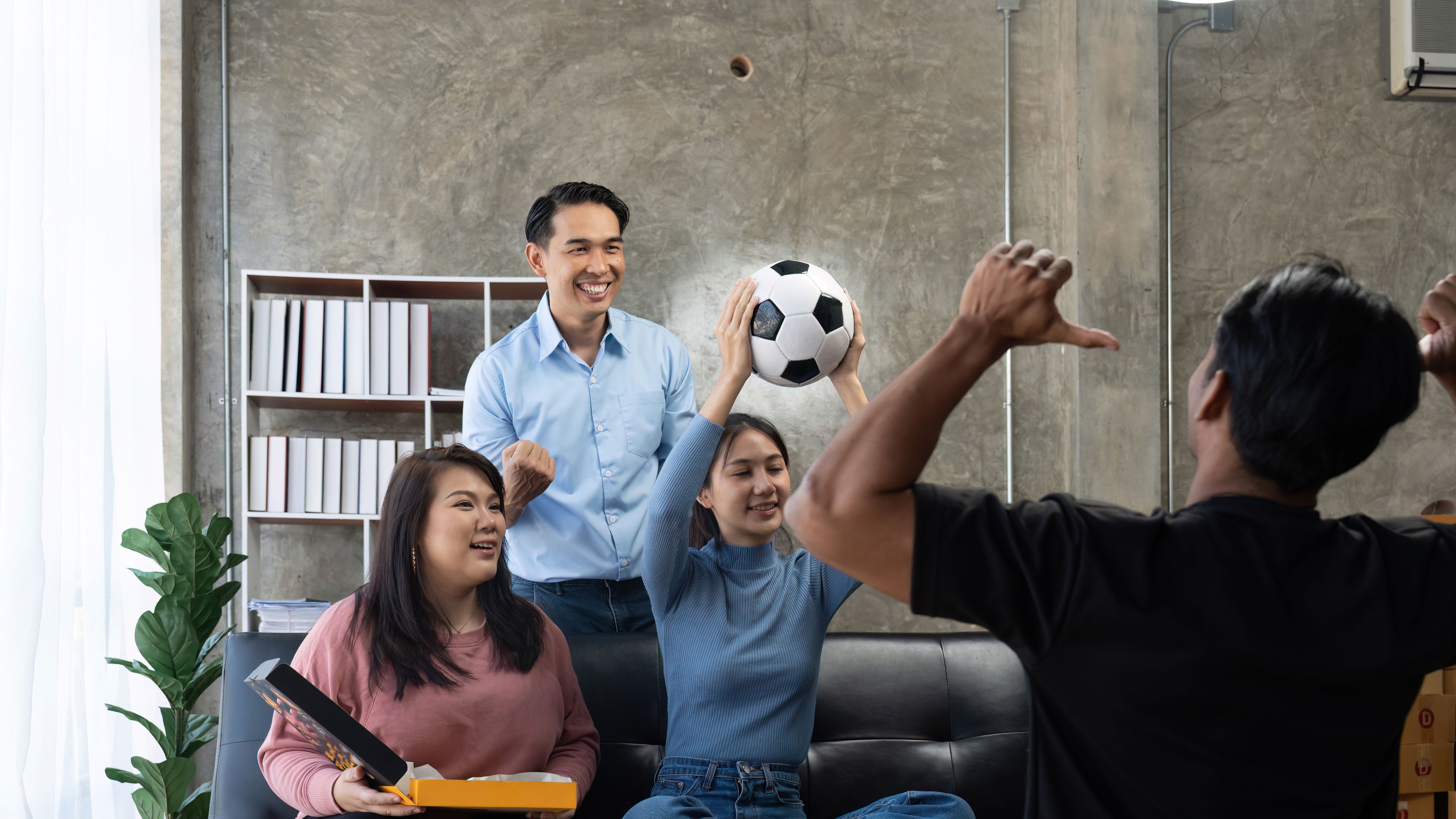 Some football fans in a home.