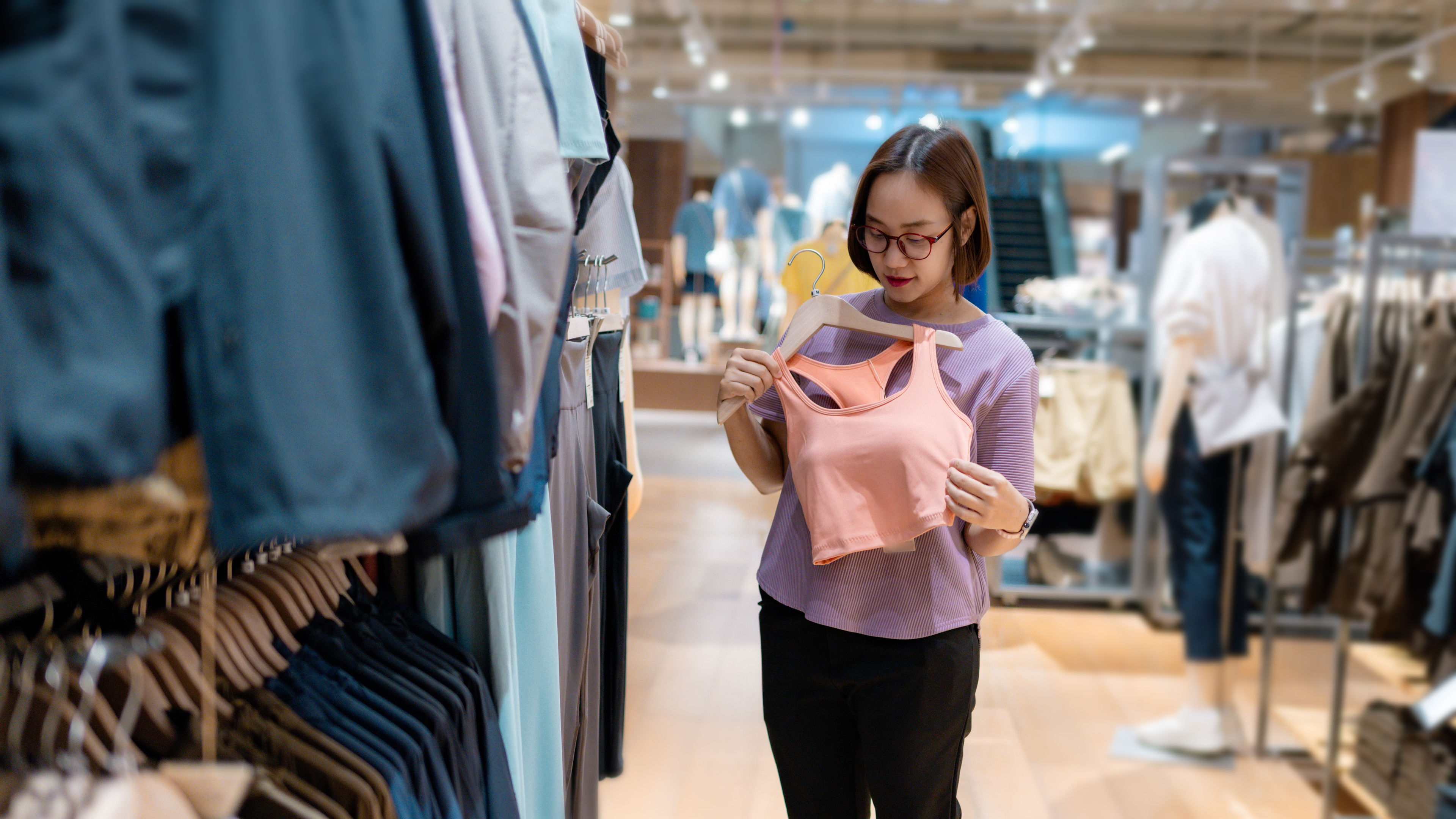Young woman choosing sports bra